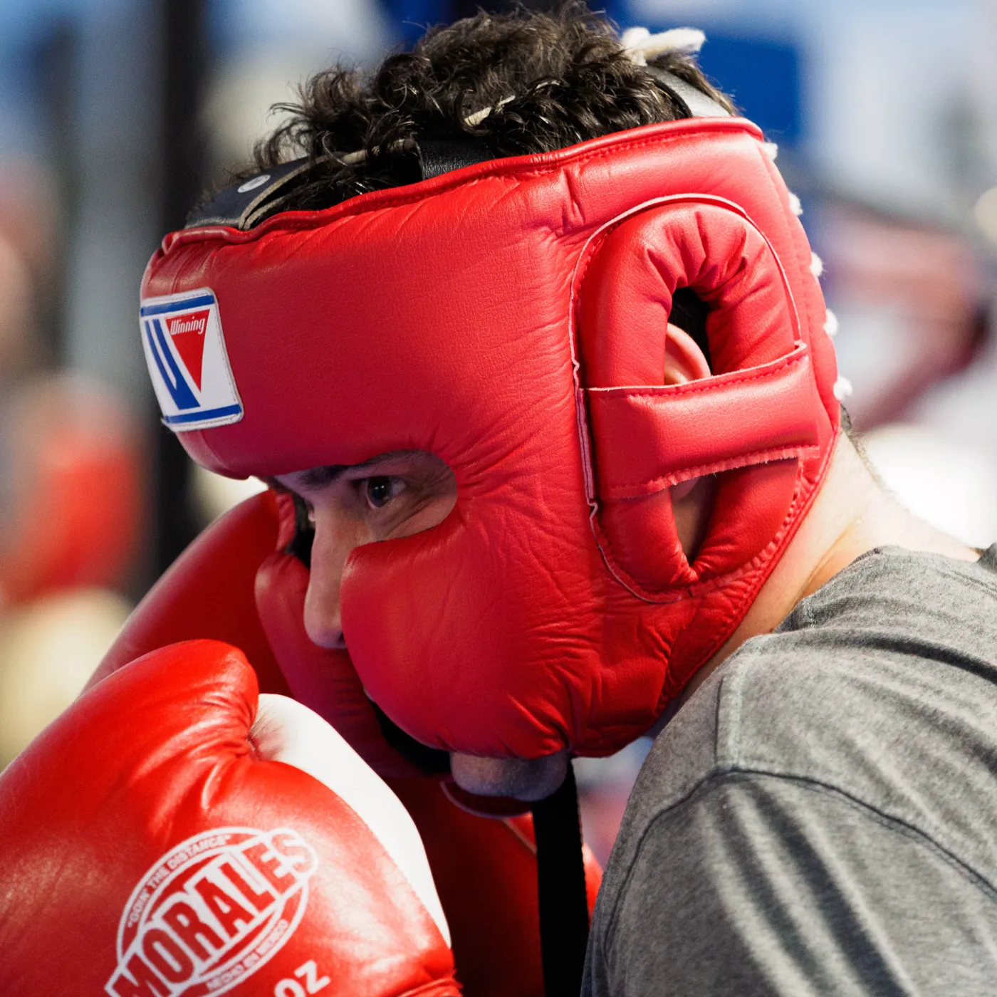 Boxer wearing open-face protective headgear