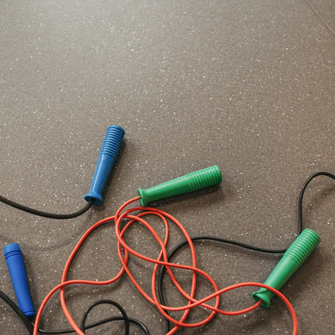 Coiled speed skipping ropes on a gym floor
