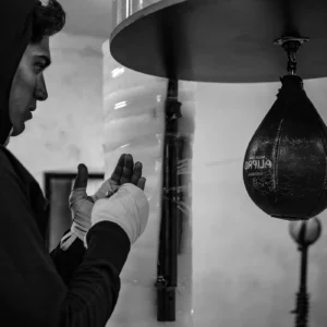 Boxer training on a leather speed bag